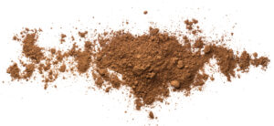 Pile Ghana cocoa powder isolated on a white background. Radad International