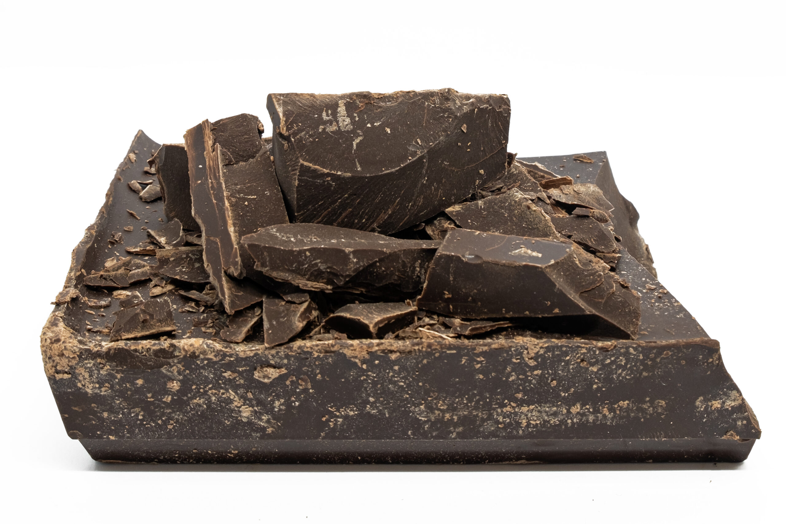 dark chocolate (dark cocoa mass) big chunks isolated on white background