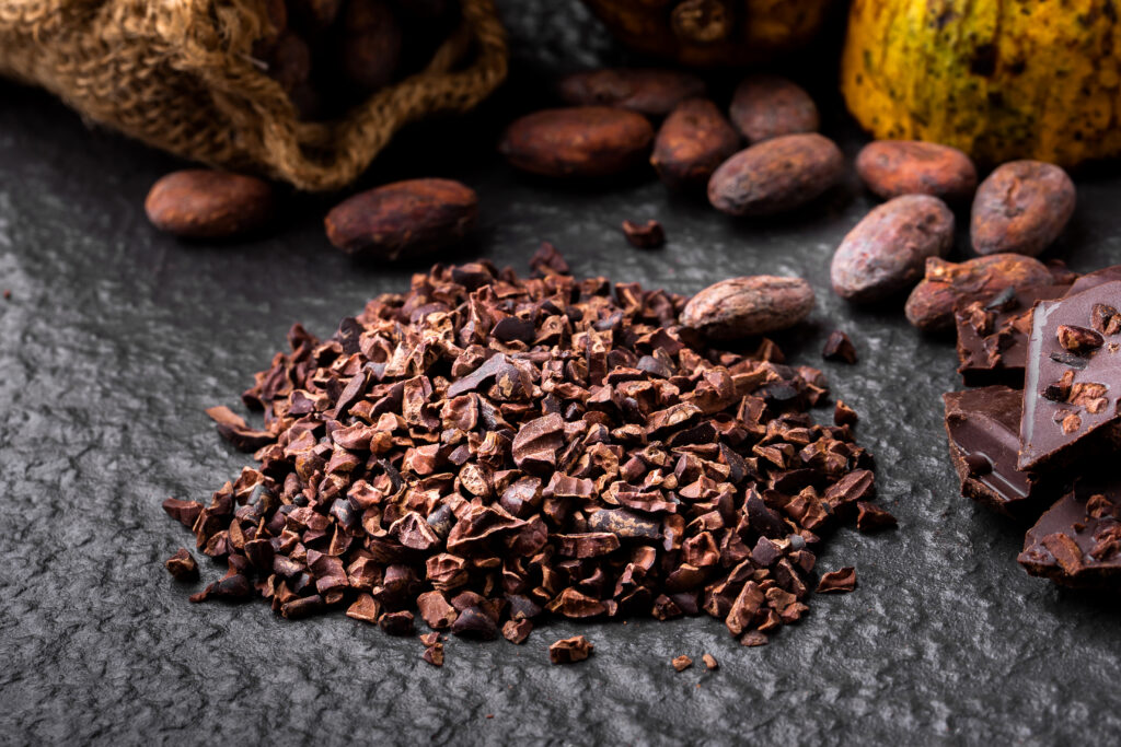 natural cocoa nibs for dark chocolate) Dark chocolate pieces crushed and cocoa beans, top view Radar International