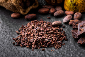 natural cocoa nibs for dark chocolate) Dark chocolate pieces crushed and cocoa beans, top view Radar International